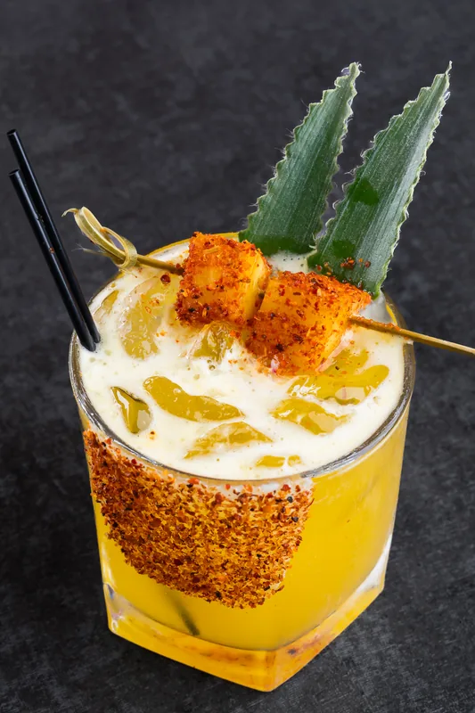 Spicy mango cocktail with a Tajin rim