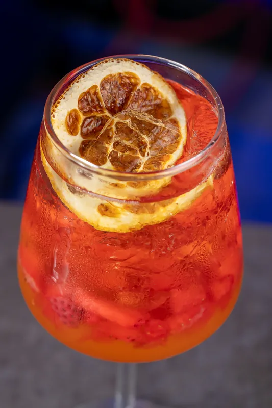 Red sangria with a dried orange wheel at KamiKoi