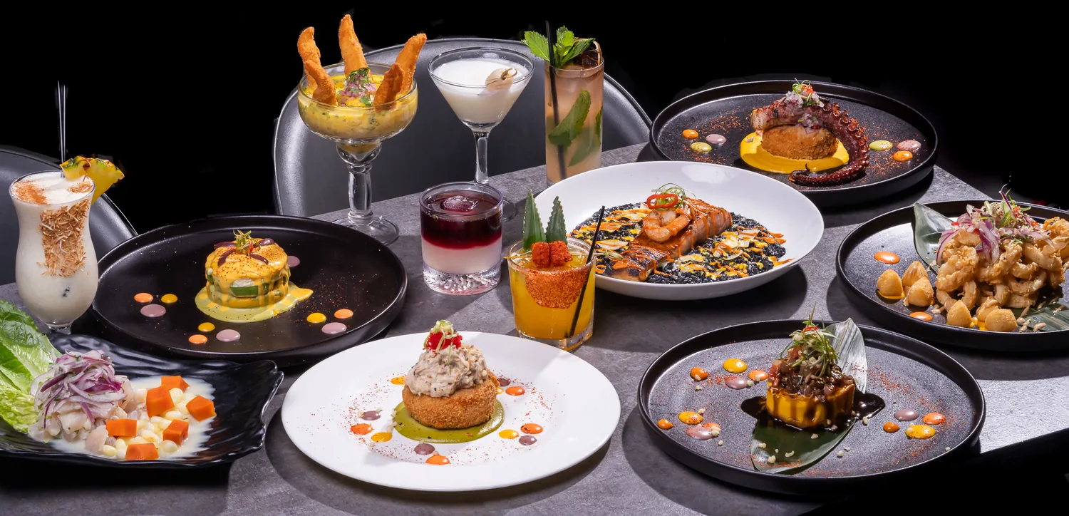 Sushi, Nikkei plates and cocktails spread across a table at KamiKoi Sushi Fusion in Miami